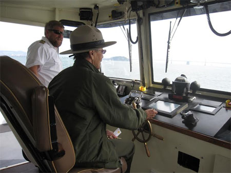 Betty Reid Soskin, standing beside a boat captain and